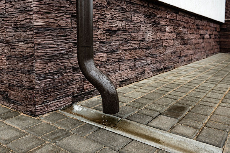 Clear Clogged Downspouts Before Water Damage Starts